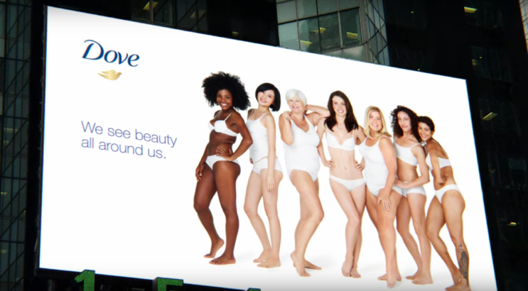 a billboard showing an advertisement for Dove with 7 women models posing and the text ‘Dove We see beauty all around us’ written on it